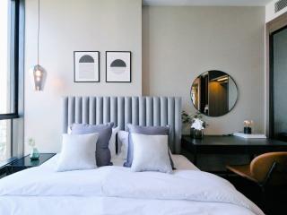 Elegant modern bedroom with a large bed and artistic wall decorations