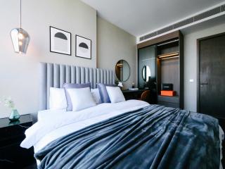Modern bedroom interior with a comfortable bed, artwork, and stylish furnishings