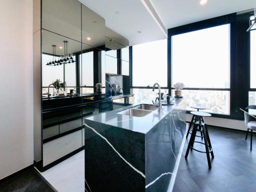 Modern kitchen with marble countertops and city view