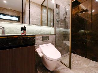 Modern bathroom with glass-enclosed shower and marble finishes