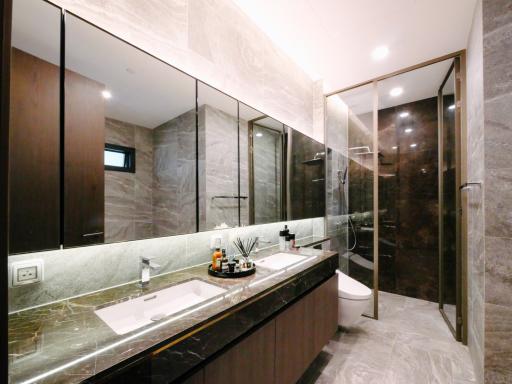 Modern bathroom with glass shower and marble finishes