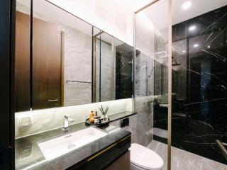 Modern bathroom with marble finish and glass shower enclosure