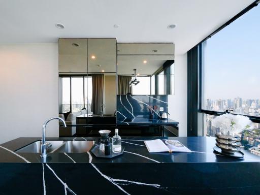 Modern kitchen with marble countertops and city view