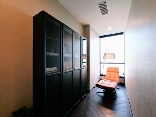 Modern home office with large window and black shelving unit