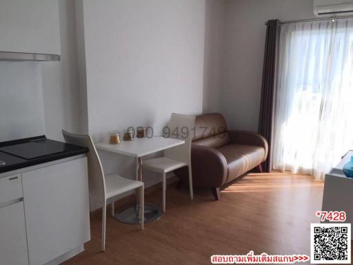 Compact living space with kitchenette, dining area, and sofa