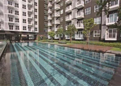 Swimming pool with modern residential buildings in the background