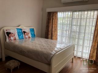 Bright and cozy bedroom with large window and air conditioning unit
