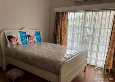 Bright and cozy bedroom with large window and air conditioning unit