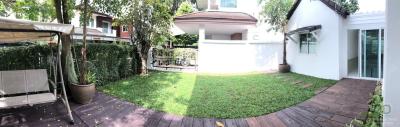 Spacious backyard with well-maintained lawn and garden