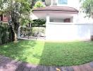 Spacious backyard with well-maintained lawn and garden