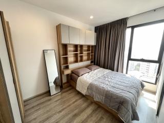 Modern bedroom with large window and built-in shelving