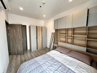 Spacious bedroom with large bed and built-in wooden wardrobes