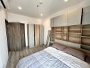 Spacious bedroom with large bed and built-in wooden wardrobes