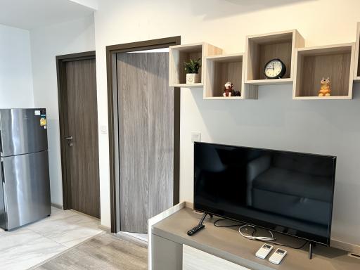 Modern living room with television and decorative shelving