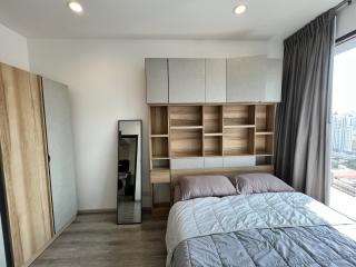 Modern bedroom with large bed and built-in wooden shelving