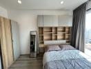Modern bedroom with large bed and built-in wooden shelving