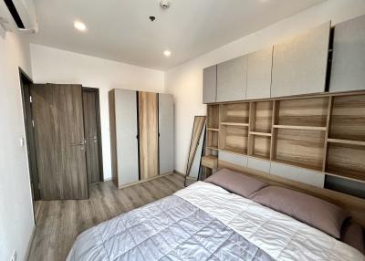 Modern bedroom with large bed and built-in wooden wardrobes