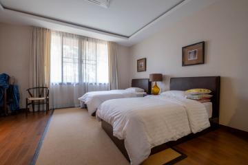 Spacious bedroom with large windows and double beds