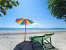 Beachfront relaxing spot with colorful umbrella and lounge chair