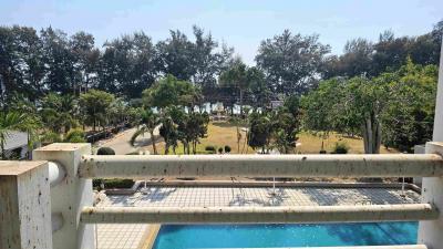 Balcony view overlooking a pool and garden