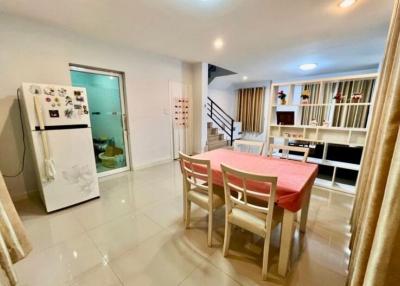 Spacious interior with dining area, open staircase, and modern kitchen