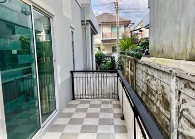 Small balcony with checkered floor and metal railing