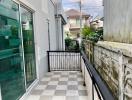 Small balcony with checkered floor and metal railing