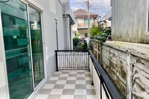 Small balcony with checkered floor and metal railing