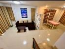 Spacious modern living room with glossy tiled flooring, comfortable furniture and bright lighting
