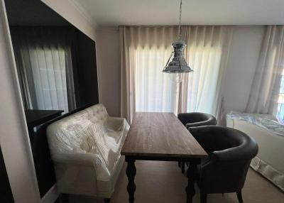 Cozy dining area with a wooden table, contemporary chairs and an elegant pendant light