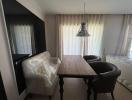 Cozy dining area with a wooden table, contemporary chairs and an elegant pendant light