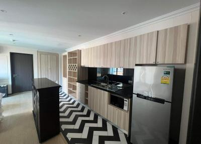 Modern kitchen with built-in appliances and black and white flooring