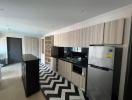 Modern kitchen with built-in appliances and black and white flooring