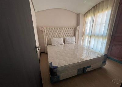 Cozy bedroom with a large tufted headboard and natural light