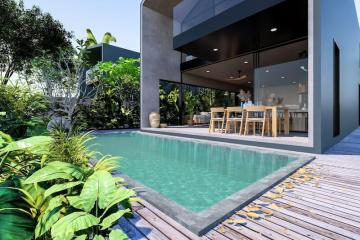 Modern home exterior with pool and outdoor dining area