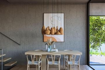 Modern dining room with a wooden table, stylish chairs, and a painting on the wall