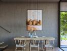 Modern dining room with a wooden table, stylish chairs, and a painting on the wall