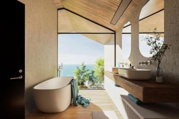 Luxurious bathroom with a freestanding bathtub, dual sinks, and a scenic sea view