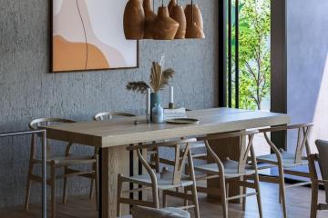 Modern dining room interior with wooden furniture and decorative plants