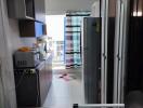 Compact apartment interior view showing the kitchen and the living area