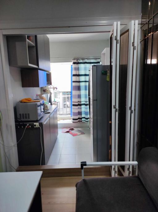 Compact apartment interior view showing the kitchen and the living area