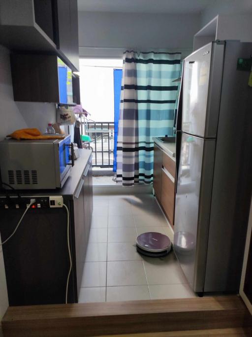 Modern kitchen with stainless steel appliances and balcony access