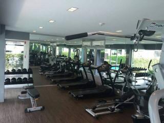 Modern gym with a variety of exercise equipment in a well-lit room