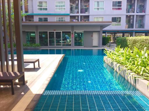 Outdoor swimming pool area at a modern apartment complex