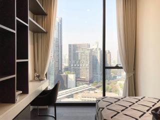 Modern bedroom with city view and natural lighting