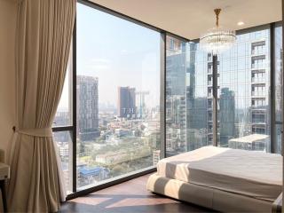 Modern bedroom with a large window offering a city view