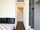 Modern bedroom with black sofa and geometric bedding