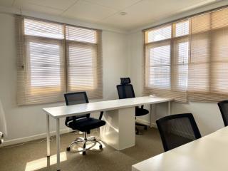 Bright and modern office space with desk and chairs