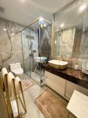 Modern bathroom with walk-in shower and marble detailing