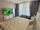 Spacious modern bedroom with large bed and mounted television